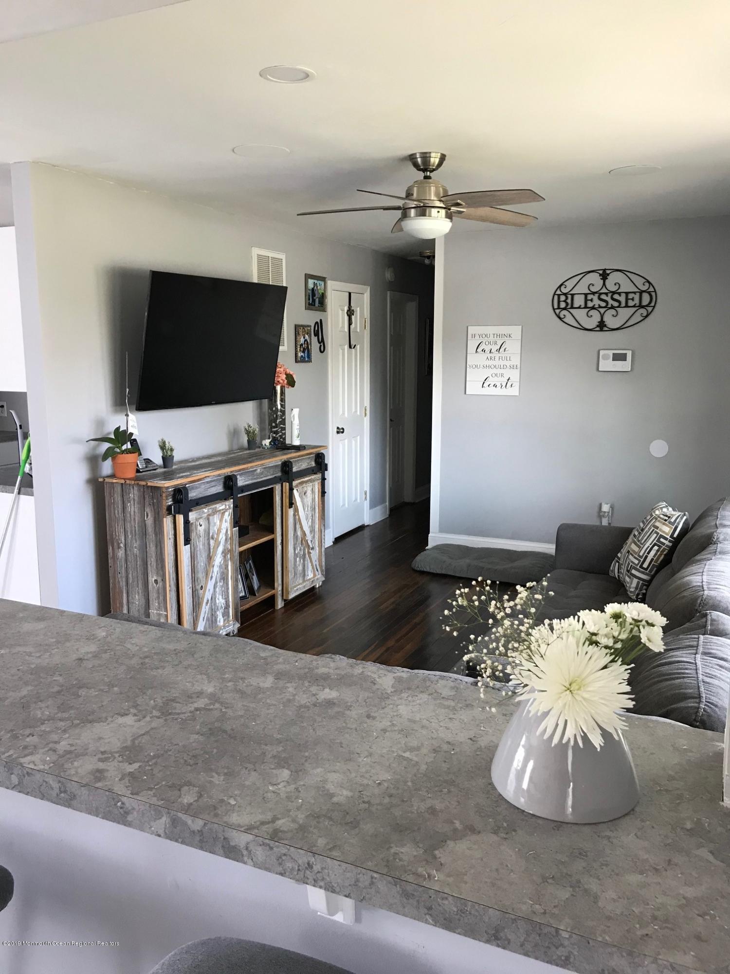 14 Chain Boulevard Bayville, NJ 08721 - Photo 10 of 17 a living room with furniture and a flat screen tv