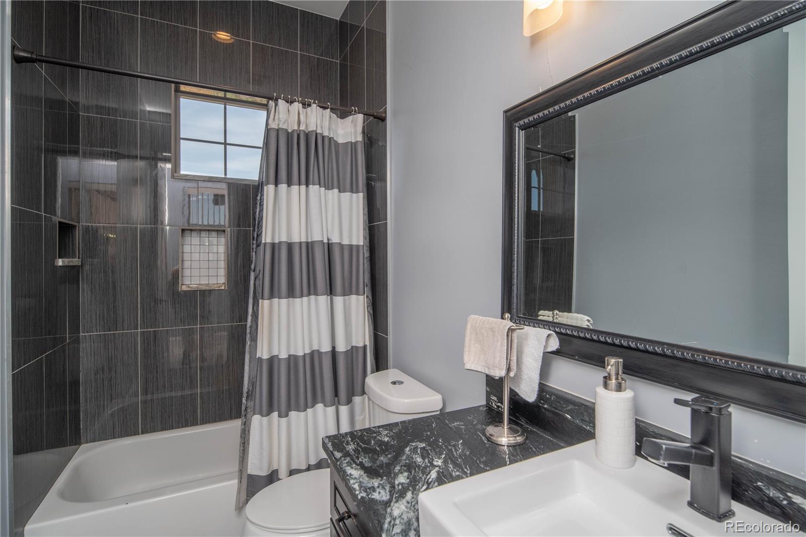 9368-41 41st Fort Fort Lupton, CO 80621 - Photo 17 of 44 a bathroom with a sink and a shower