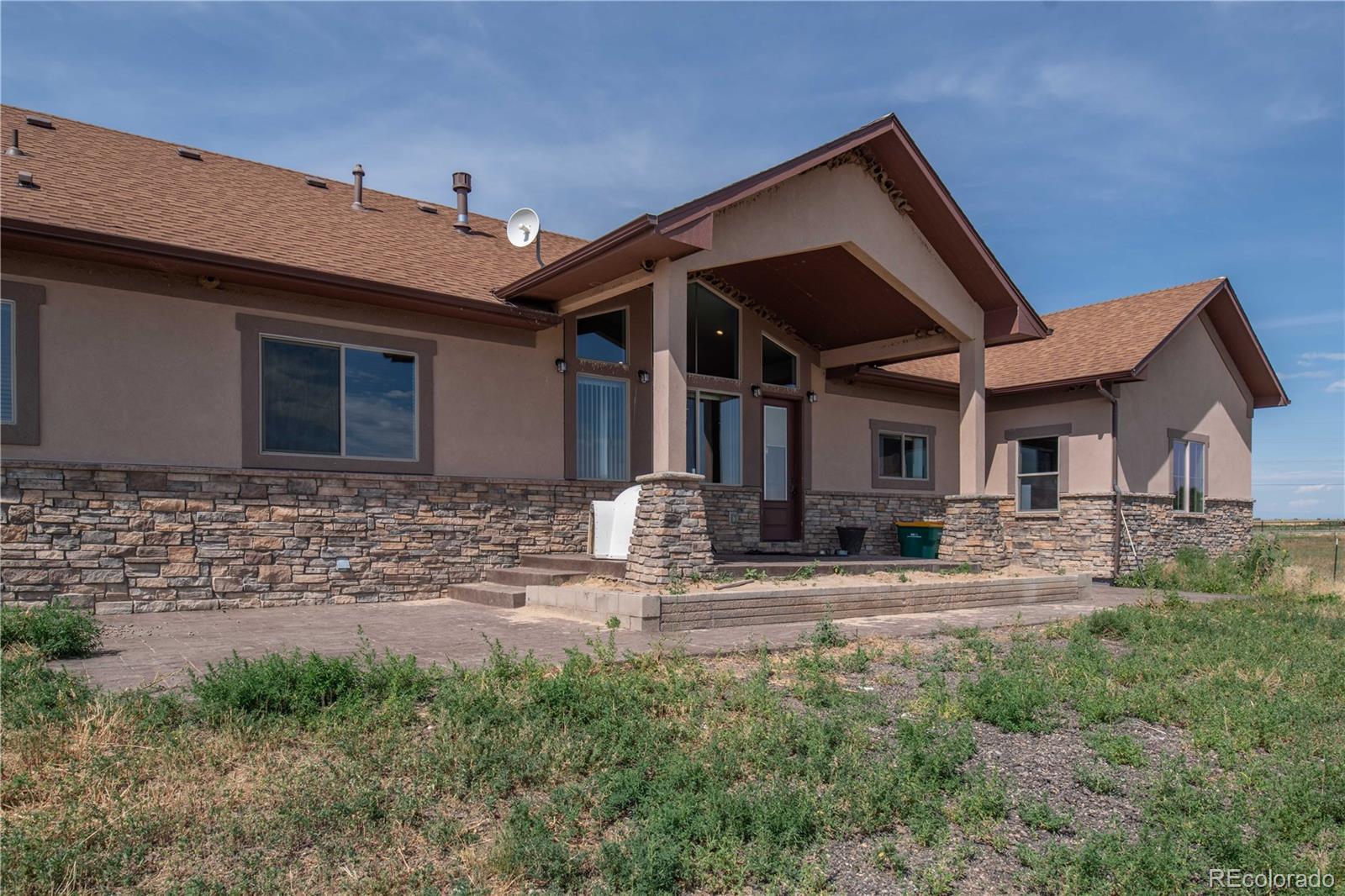 9368-41 41st Fort Fort Lupton, CO 80621 - Photo 2 of 44 a front view of a house with garden