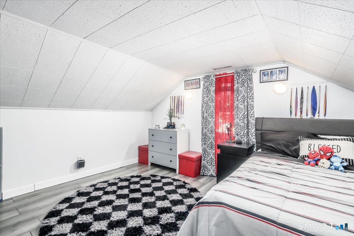 306 Welton Street Hamden, CT 06517 - Photo 24 of 38 a bedroom with a bed and a window