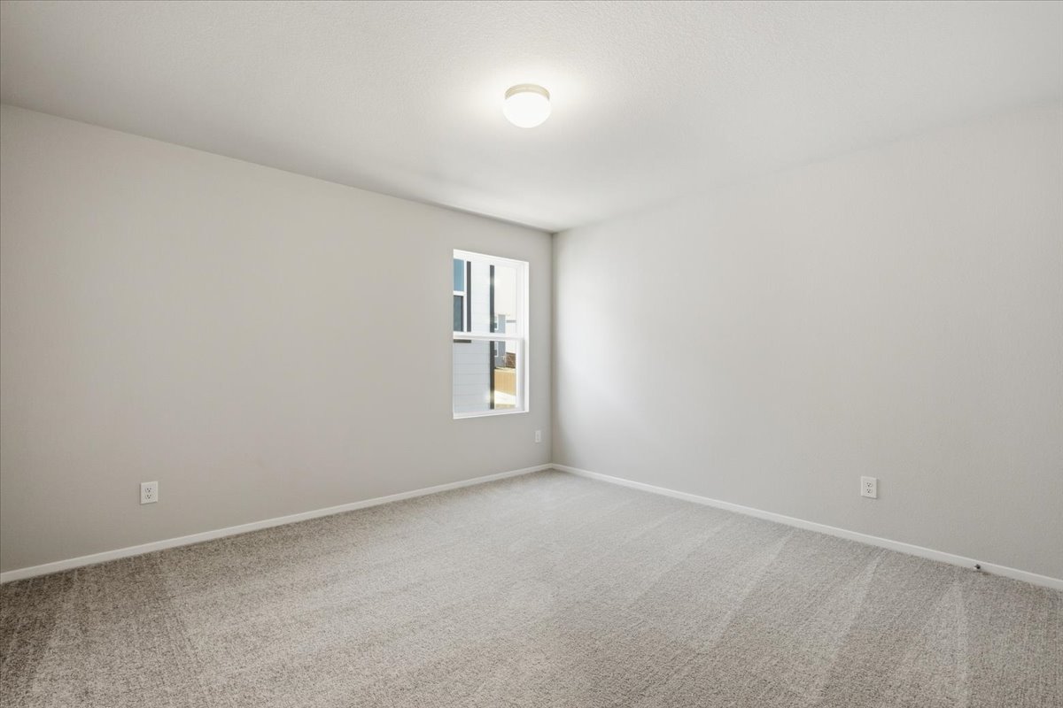 2714 Foss Road Manor, TX 78653 - Photo 28 of 34 Soft carpeting pairs with neutral walls in this versatile secondary bedroom space.