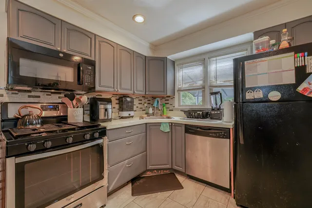 a kitchen with stainless steel appliances a stove a sink and a microwave