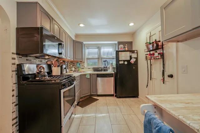a kitchen with a stove a refrigerator and a refrigerator