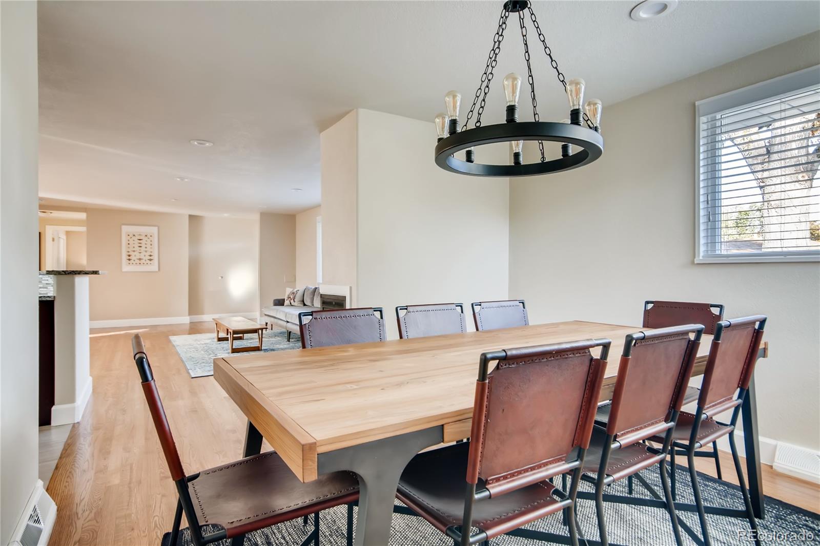 5655 Estes Street Arvada, CO 80002 - Photo 11 of 40 a view of a dining room with furniture window and wooden floor