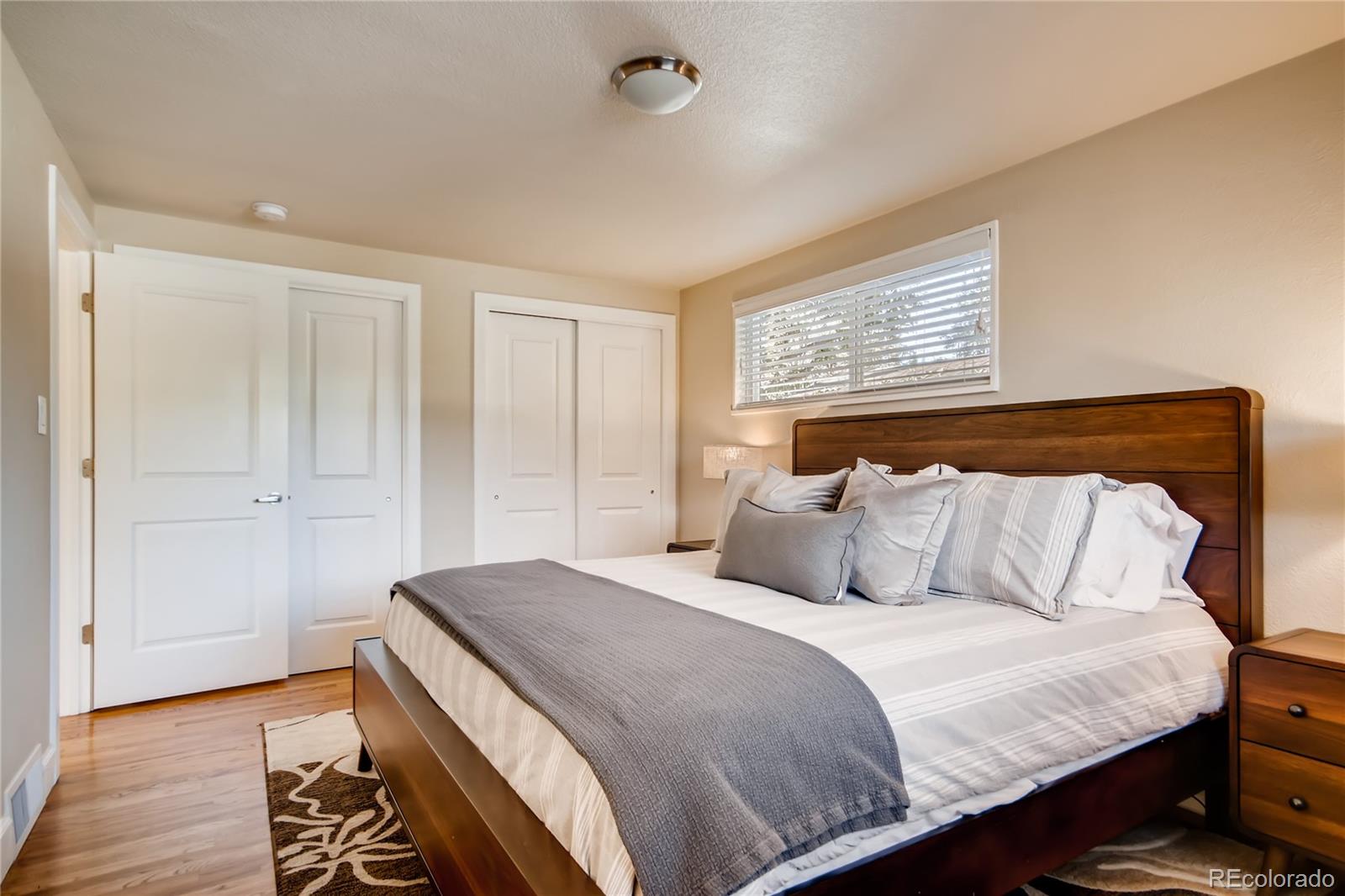 5655 Estes Street Arvada, CO 80002 - Photo 20 of 40 a bedroom with a bed and wooden floor