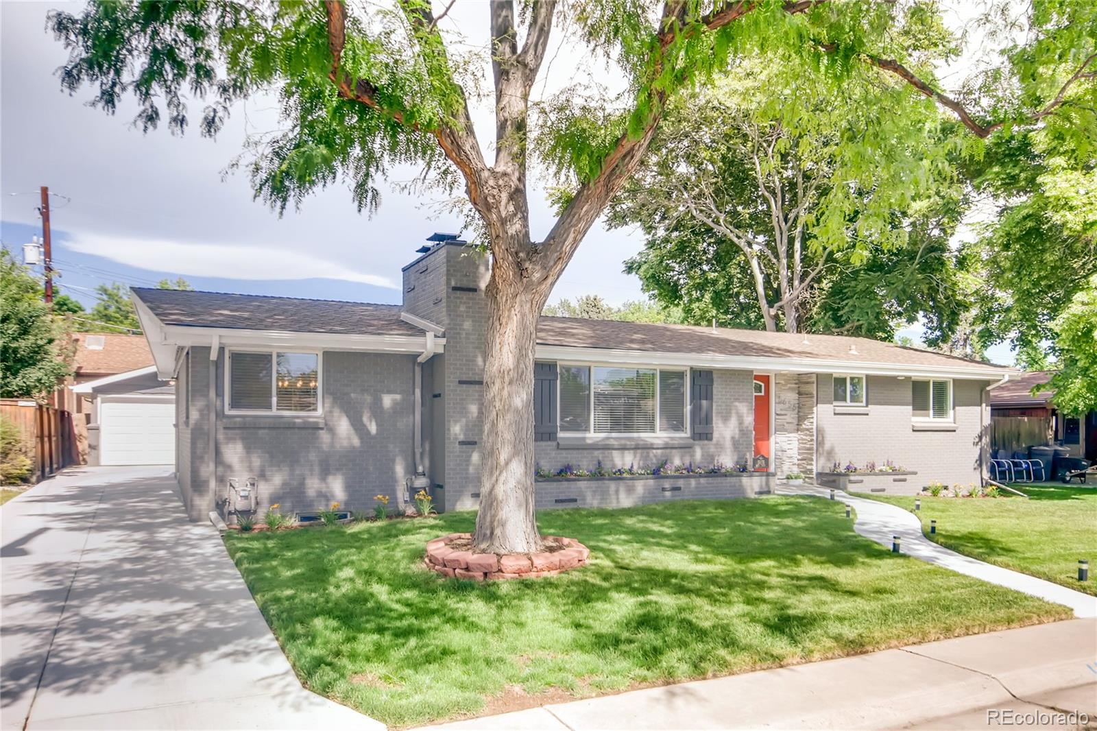 5655 Estes Street Arvada, CO 80002 - Photo 2 of 40 a front view of house with a garden and patio