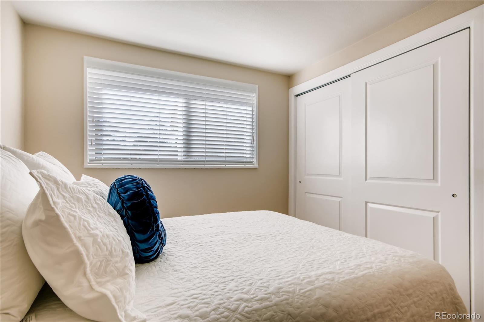 5655 Estes Street Arvada, CO 80002 - Photo 23 of 40 a bedroom with a bed and a chair