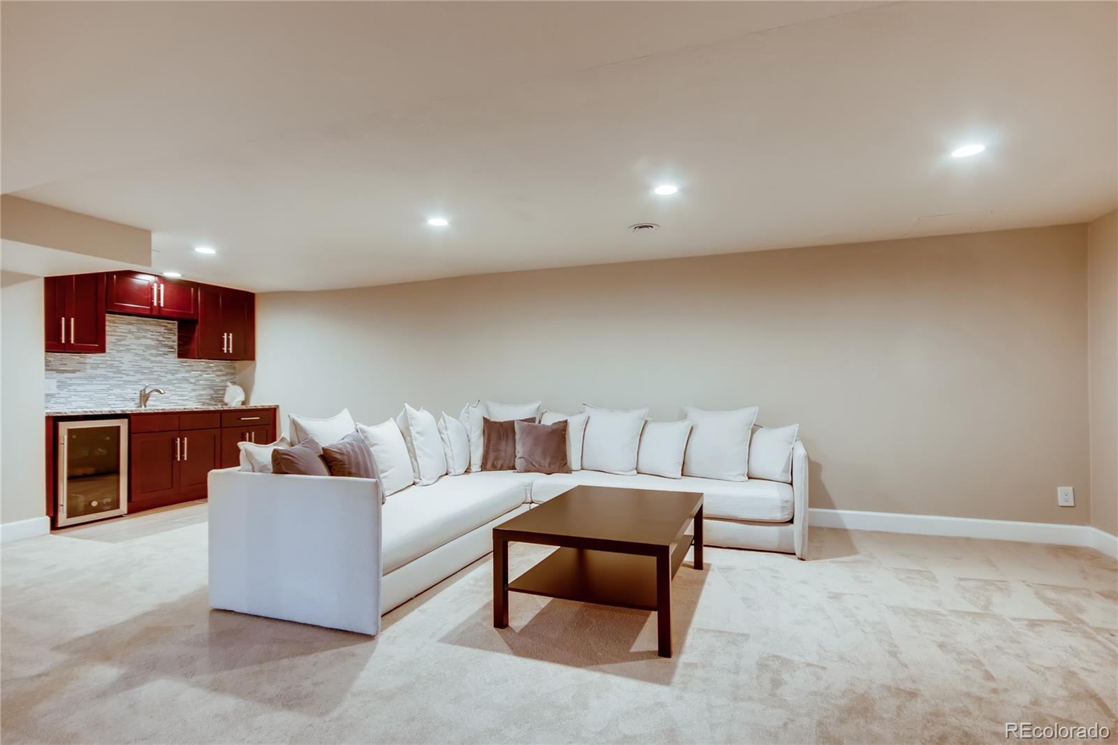 5655 Estes Street Arvada, CO 80002 - Photo 25 of 40 a living room with furniture and a fireplace