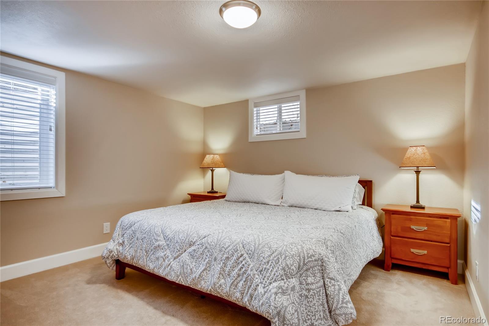 5655 Estes Street Arvada, CO 80002 - Photo 30 of 40 a bedroom with a bed and a lamp