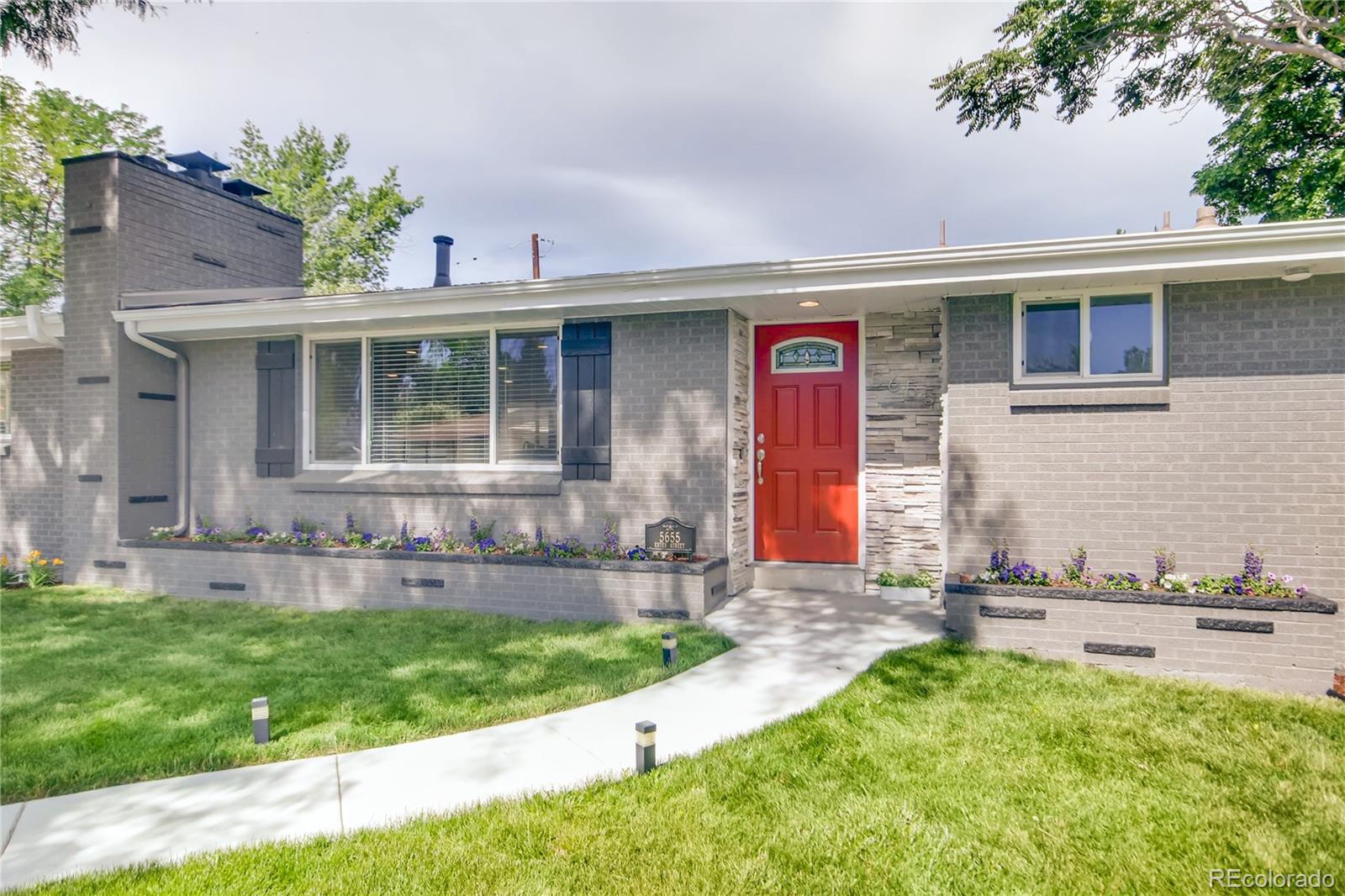 5655 Estes Street Arvada, CO 80002 - Photo 3 of 40 a front view of house with yard and outdoor seating