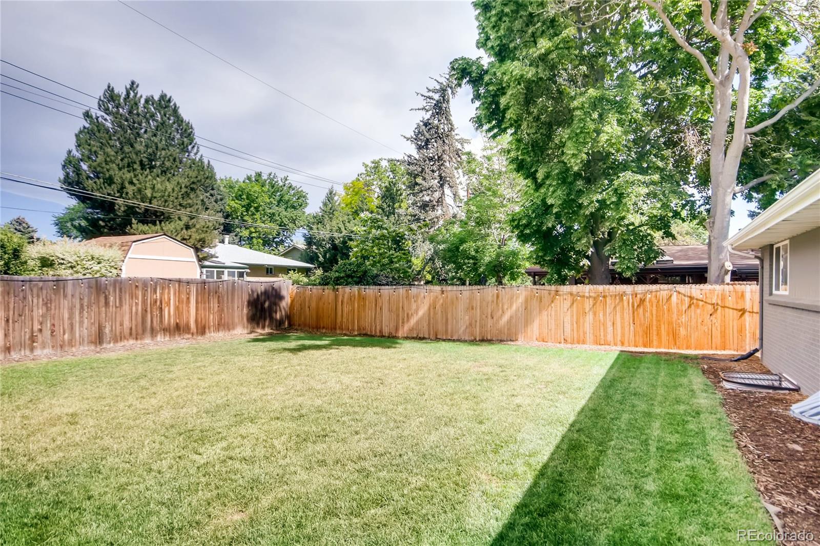 5655 Estes Street Arvada, CO 80002 - Photo 35 of 40 a view of a backyard with a small pool