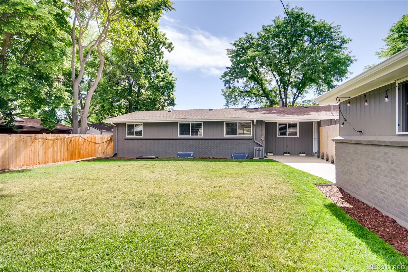 5655 Estes Street Arvada, CO 80002 - Photo 38 of 40 front view of a house with a yard