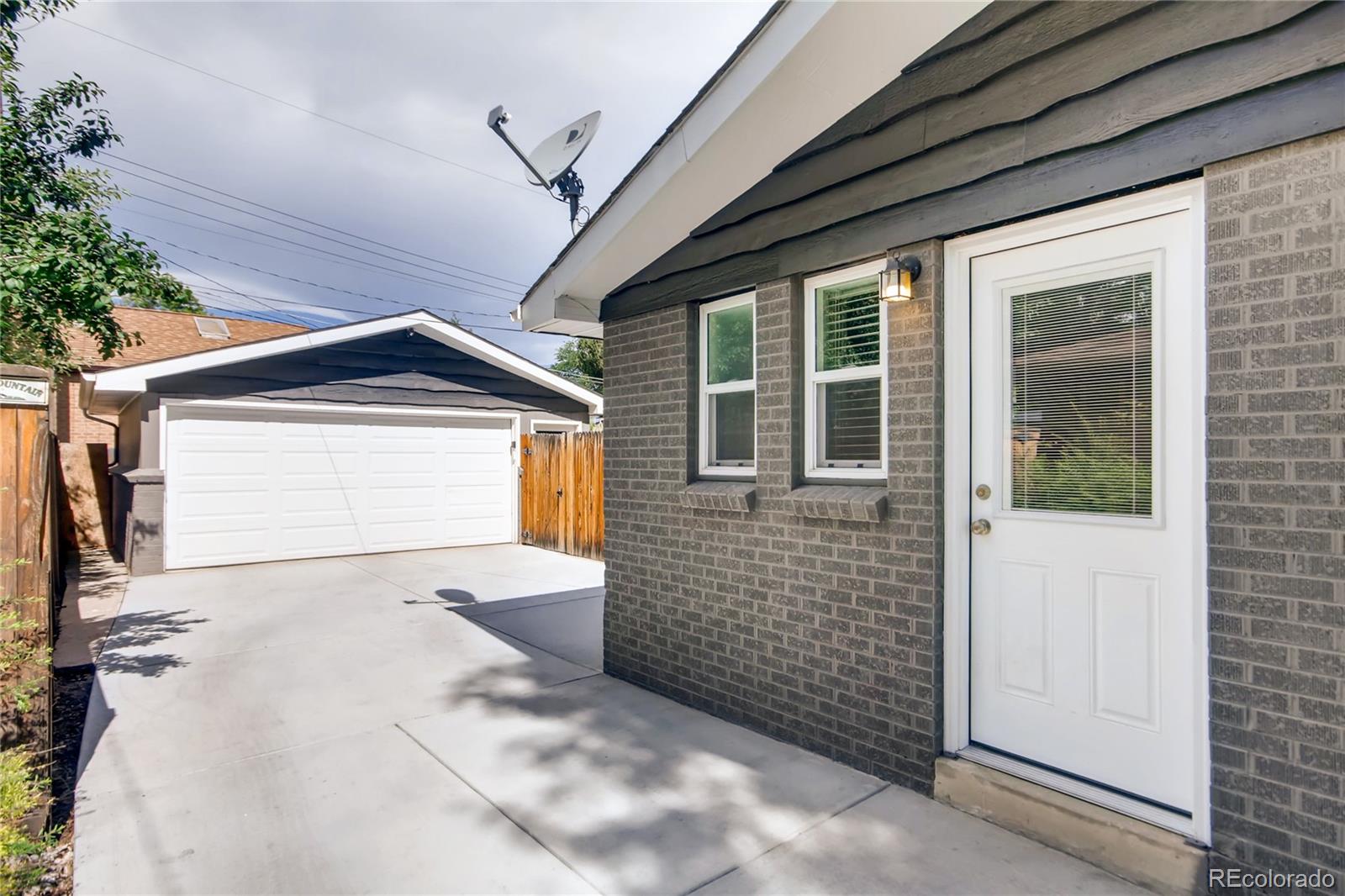 5655 Estes Street Arvada, CO 80002 - Photo 39 of 40 a front view of a house with a garage