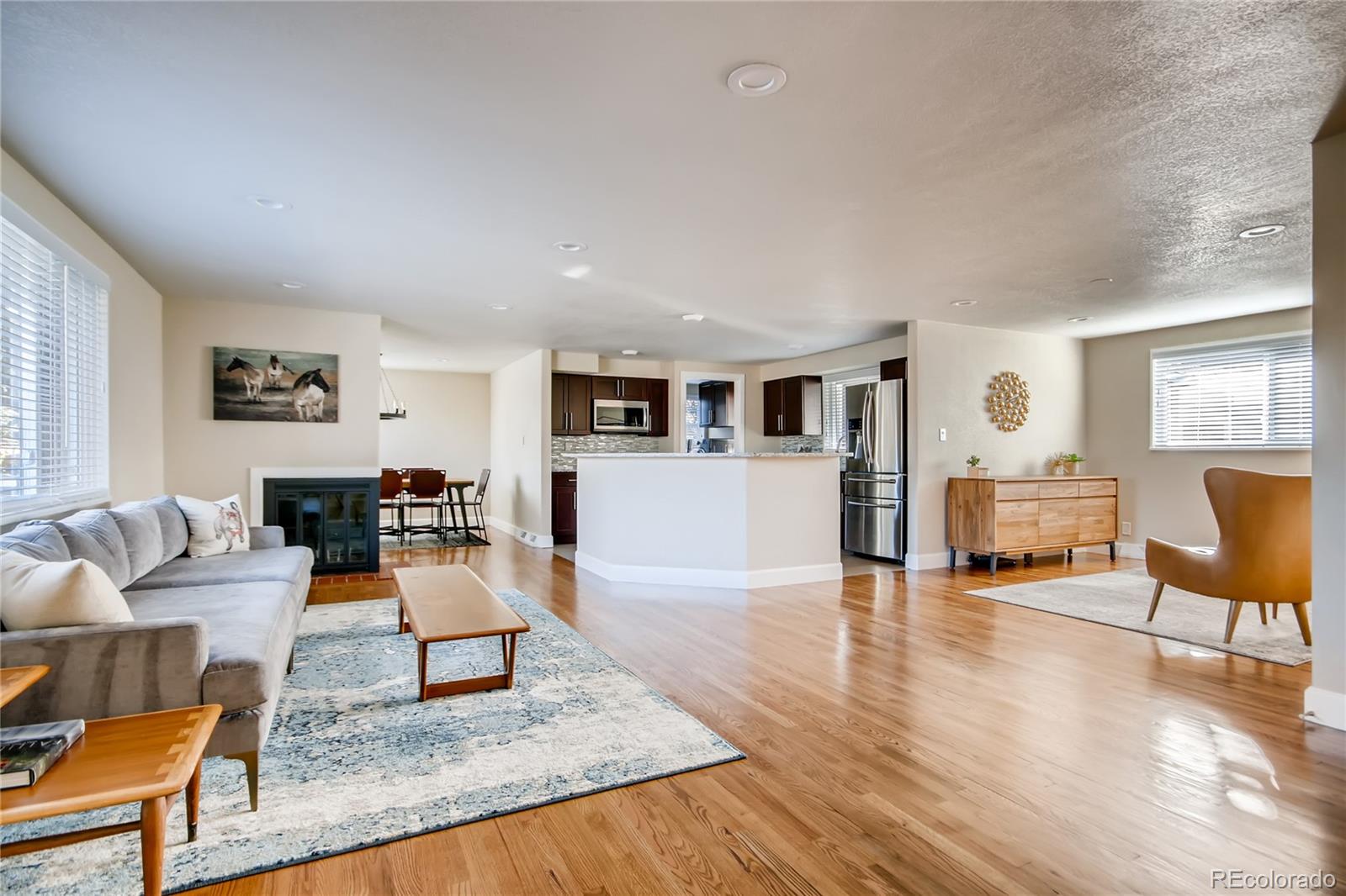 5655 Estes Street Arvada, CO 80002 - Photo 4 of 40 a living room with furniture and a wooden floor