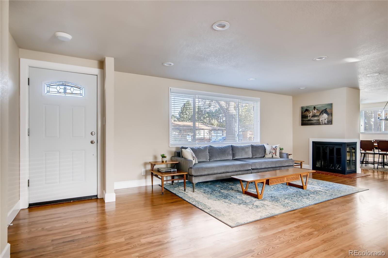 5655 Estes Street Arvada, CO 80002 - Photo 5 of 40 a living room with furniture and a fireplace