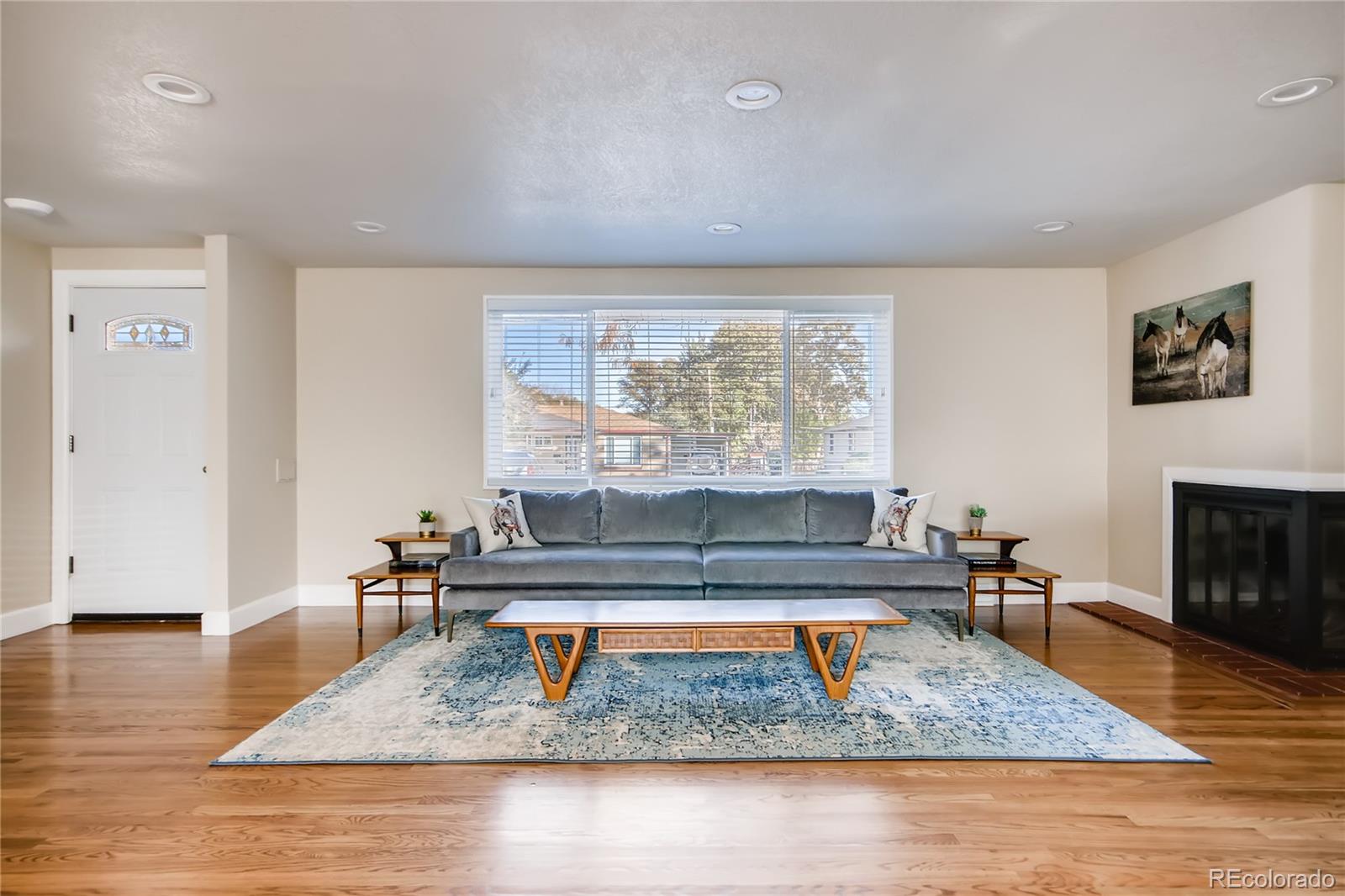 5655 Estes Street Arvada, CO 80002 - Photo 6 of 40 a living room with furniture and a wooden floor