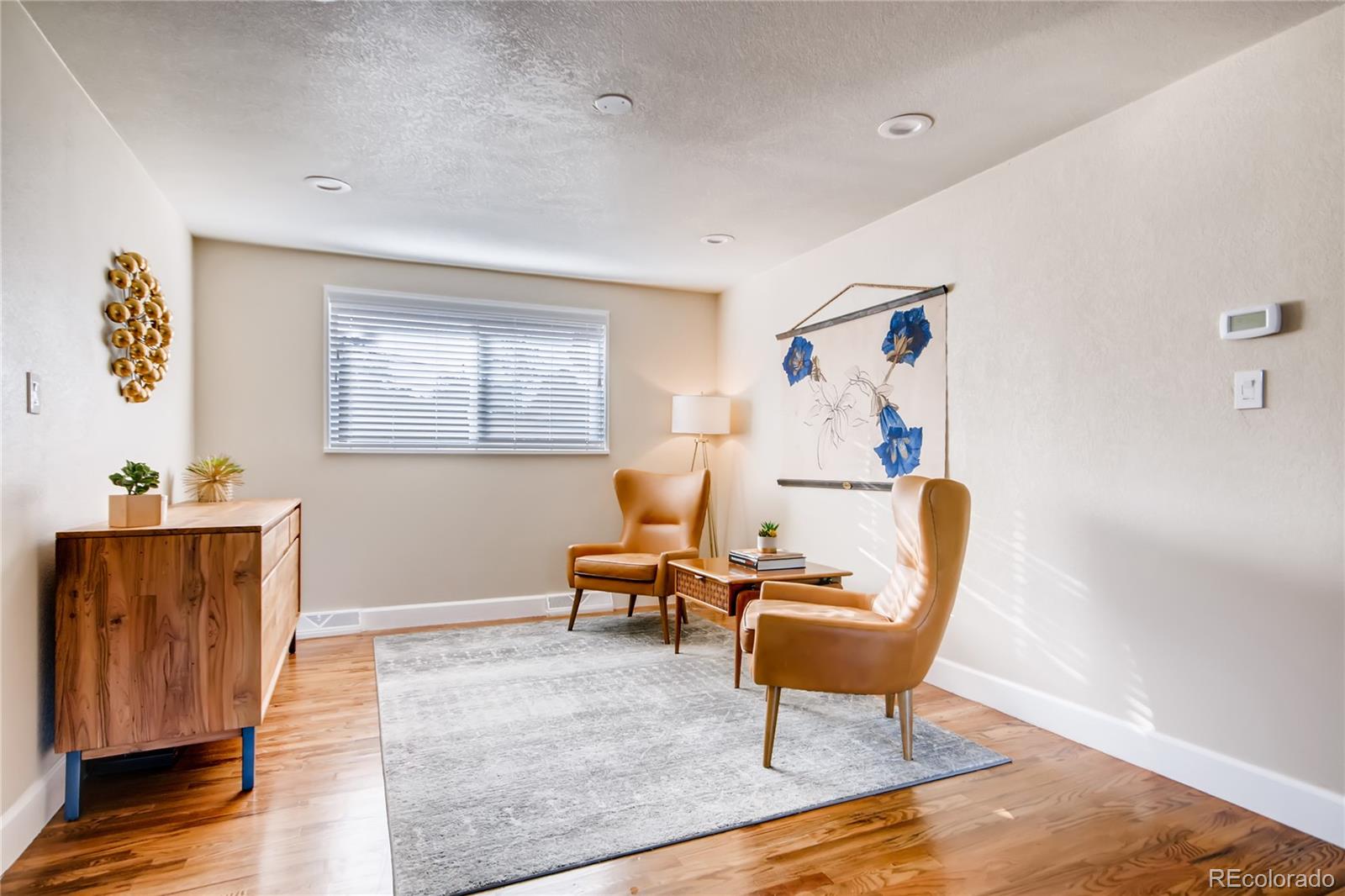 5655 Estes Street Arvada, CO 80002 - Photo 8 of 40 a living room with furniture and a window