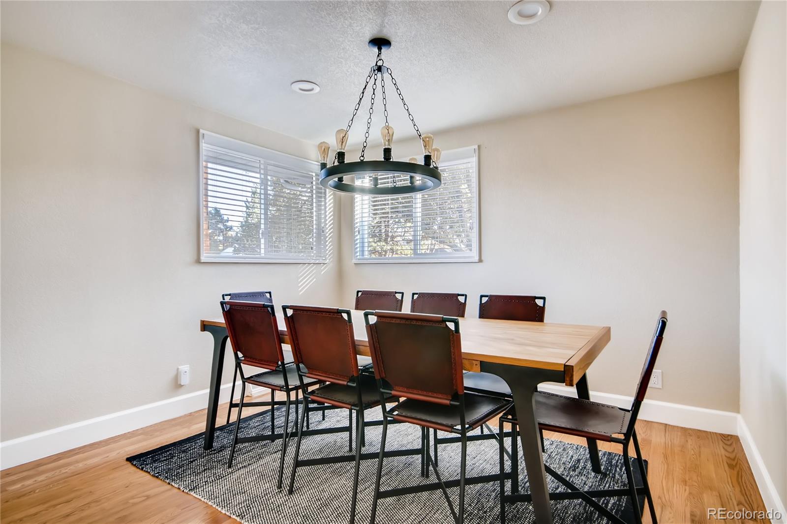 5655 Estes Street Arvada, CO 80002 - Photo 9 of 40 a view of a dining room with furniture window and wooden floor