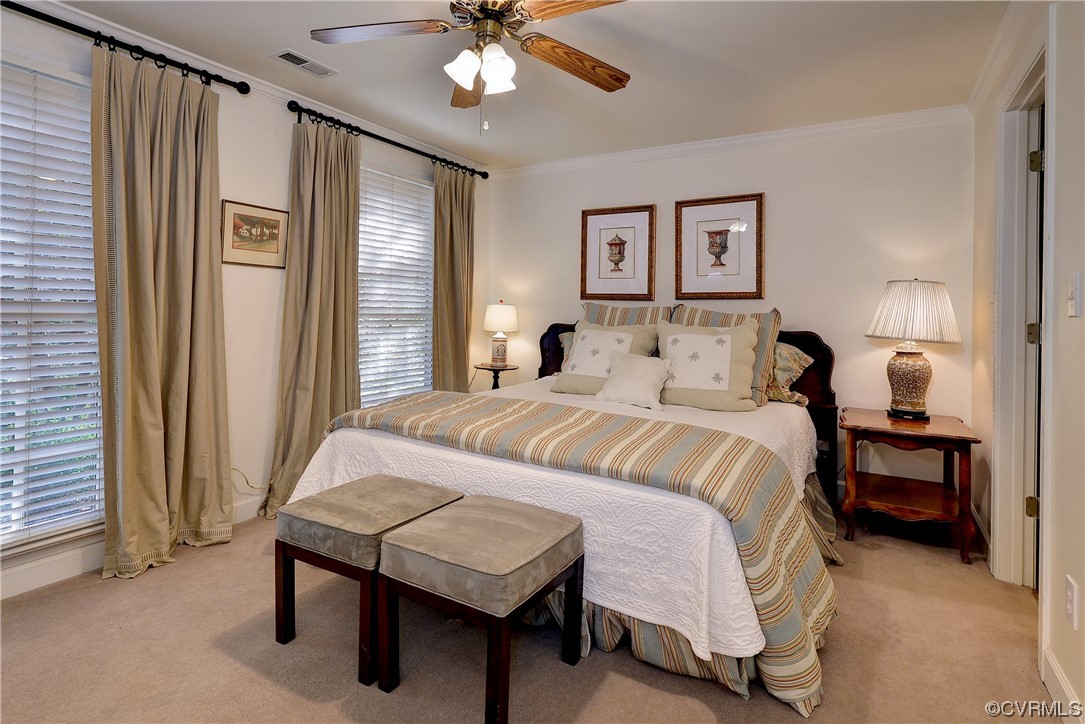 101 Spring Branch Williamsburg, VA 23185 - Photo 35 of 44 a bedroom with a bed and a chandelier