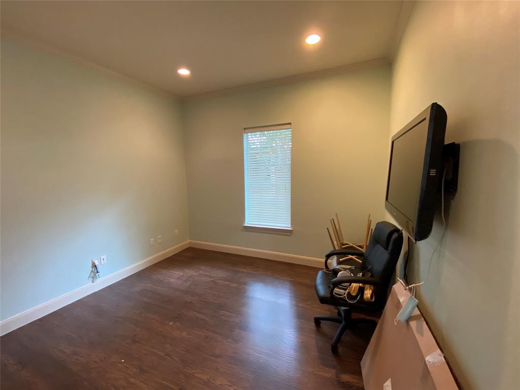 4501 Cartwright Road, Unit 408 Missouri City, TX 77459 - Photo 5 of 10 a view of a room with wooden floor and gym equipment