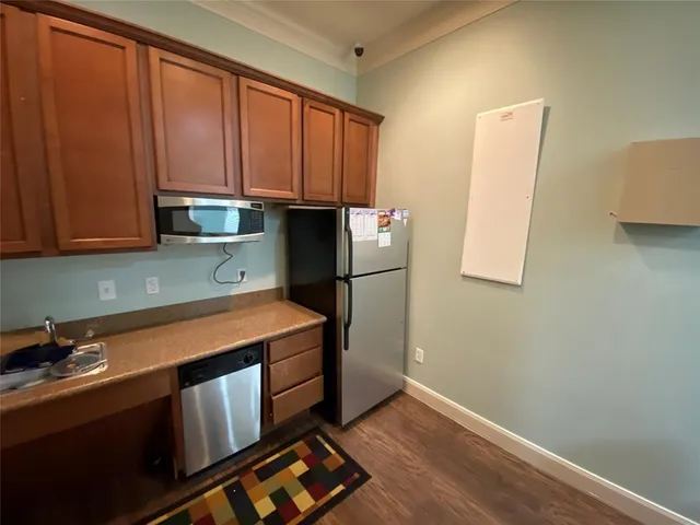 a kitchen with stainless steel appliances granite countertop a refrigerator sink and cabinets