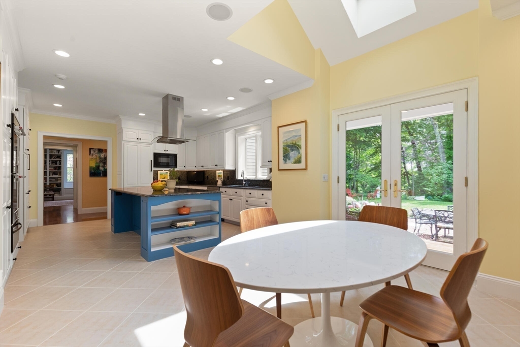 103 Revolutionary Road Concord, MA 01742 - Photo 17 of 36 a view of a dining room with furniture and a kitchen