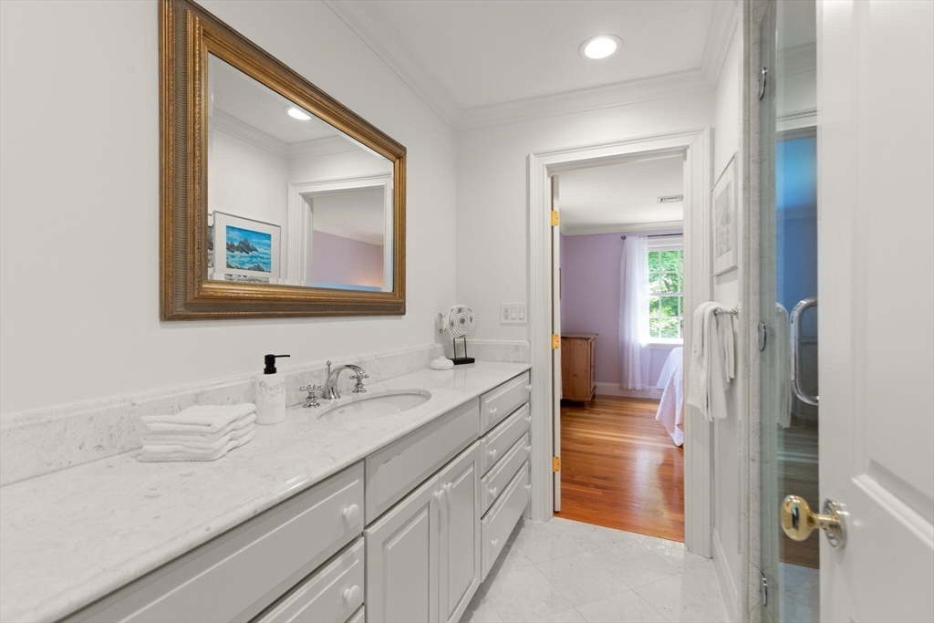 103 Revolutionary Road Concord, MA 01742 - Photo 24 of 36 a en suite bathroom with a double vanity sink and a mirror