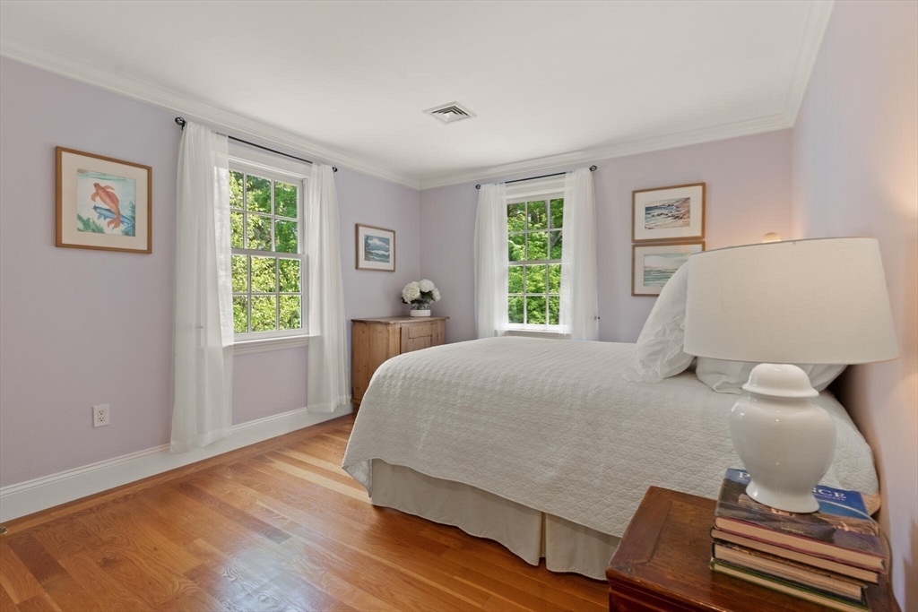 103 Revolutionary Road Concord, MA 01742 - Photo 25 of 36 a bedroom with a bed and wooden floor