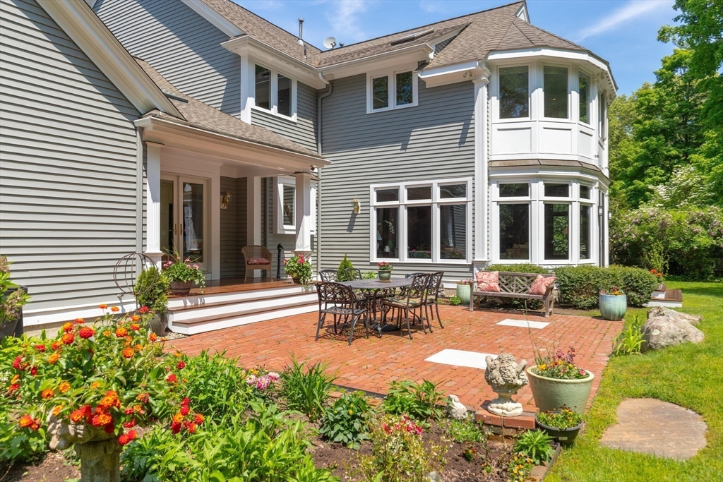 103 Revolutionary Road Concord, MA 01742 - Photo 32 of 36 a view of a house with sitting area and garden