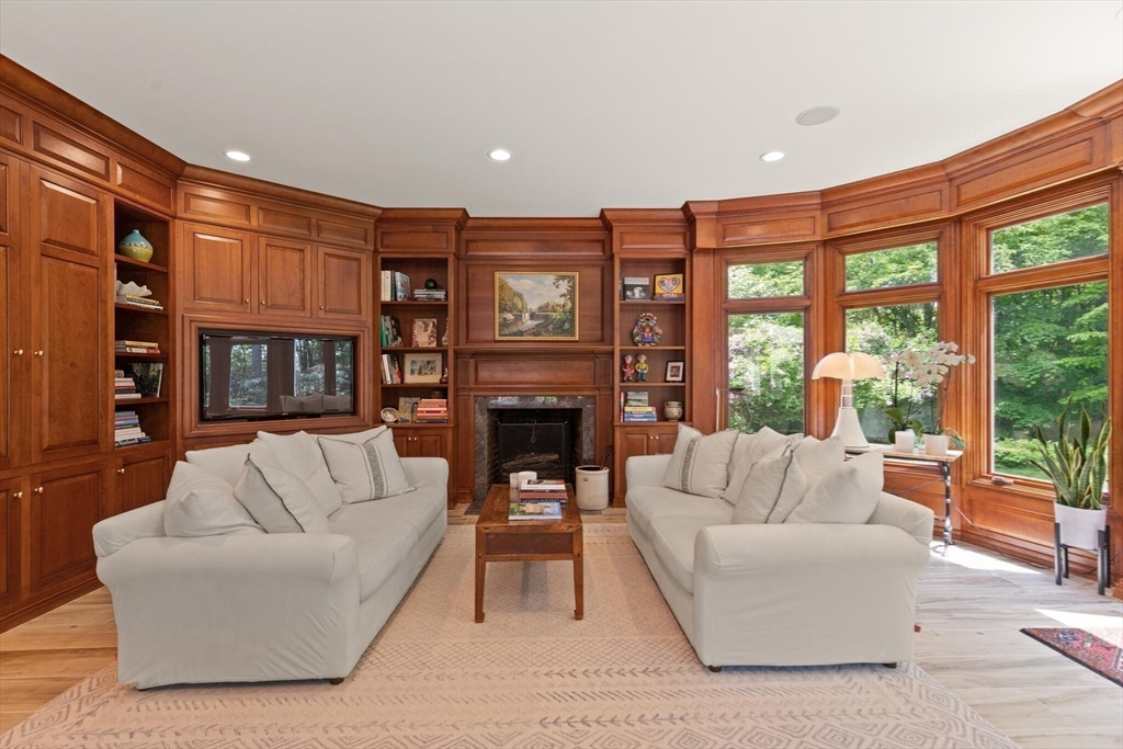103 Revolutionary Road Concord, MA 01742 - Photo 5 of 36 a living room with furniture a fireplace and a large window