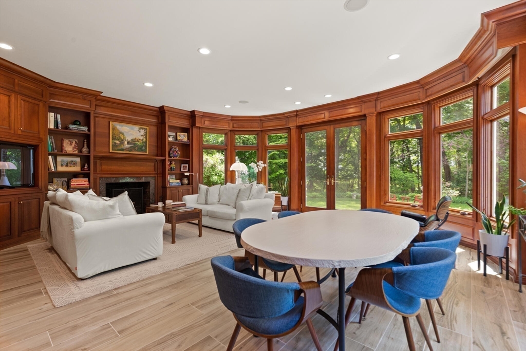 103 Revolutionary Road Concord, MA 01742 - Photo 7 of 36 a living room with furniture a fireplace and floor to ceiling windows