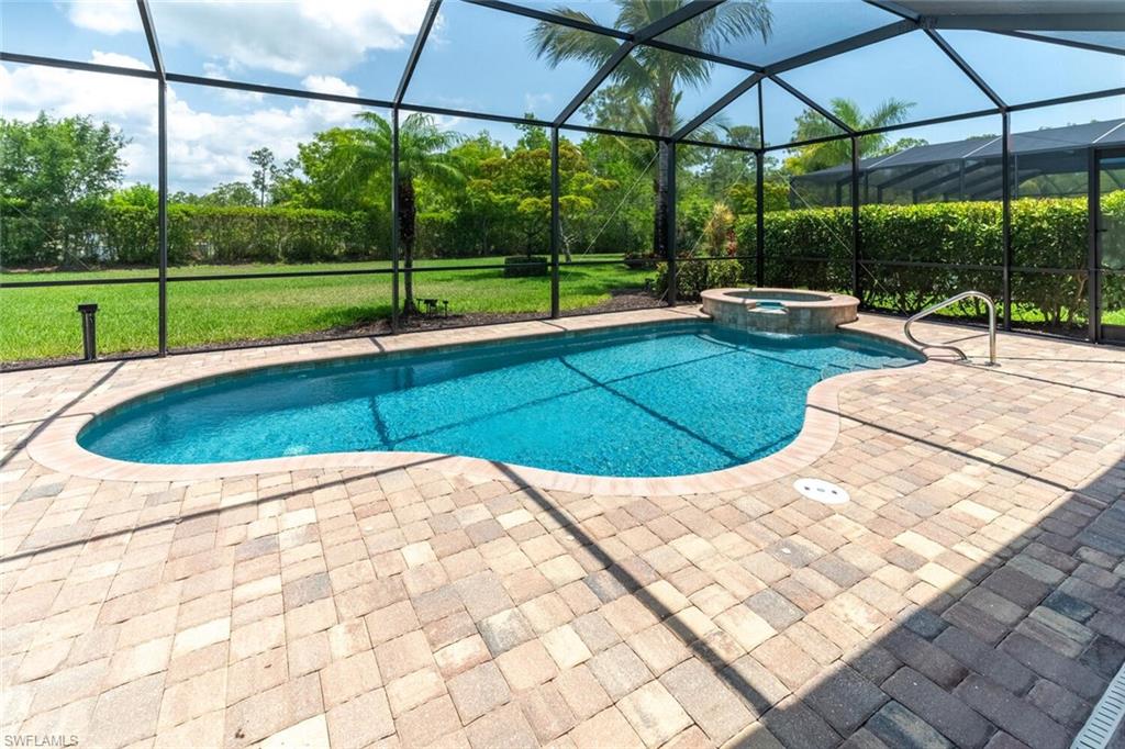 9372 Vercelli Court Naples, FL 34113 - Photo 39 of 50 View of pool featuring a patio, an in ground hot tub, a lanai, and a yard