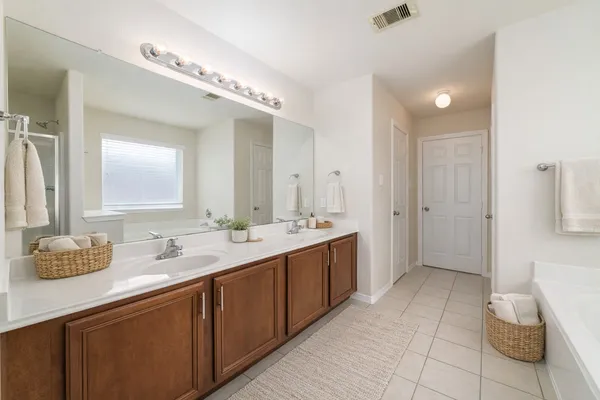 a spacious bathroom with a double vanity sink mirror and double