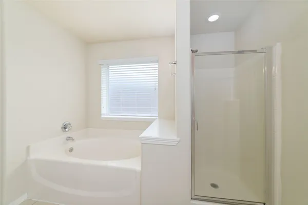 a white bath tub sitting next to a white sink
