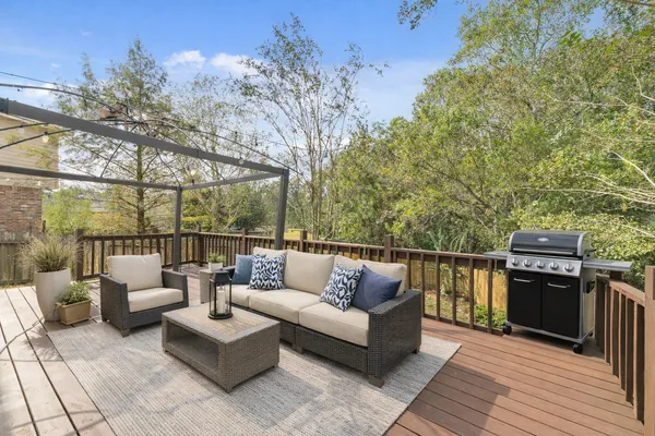 a balcony with couch and wooden floor