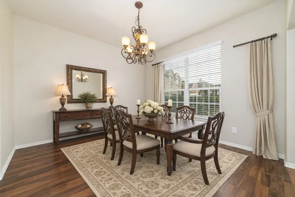 a view of a dining room with furniture window and wooden floor