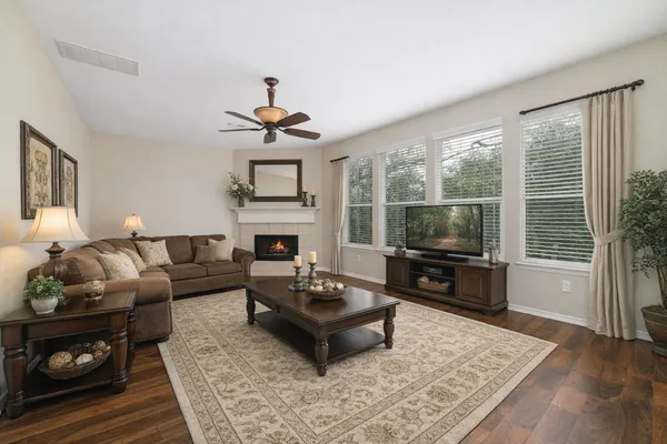 a living room with furniture a fireplace and a flat screen tv