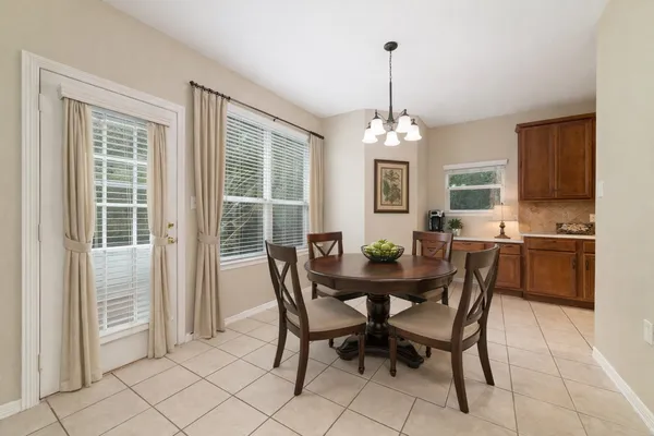 a view of a dining room with furniture and window