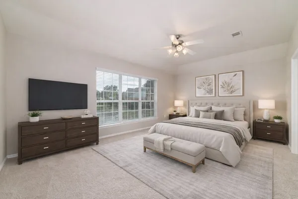 a spacious bedroom with a bed and a flat screen television