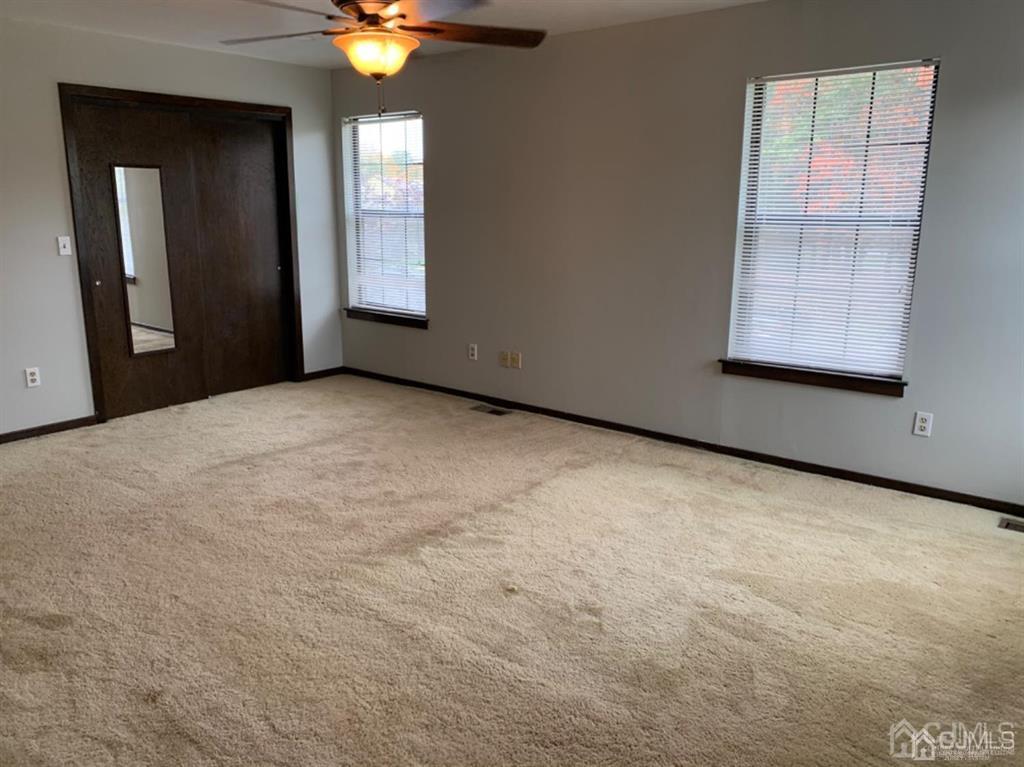 24 Pendleton Place Old Bridge, NJ 08857 - Photo 11 of 22 an empty room with windows and closet