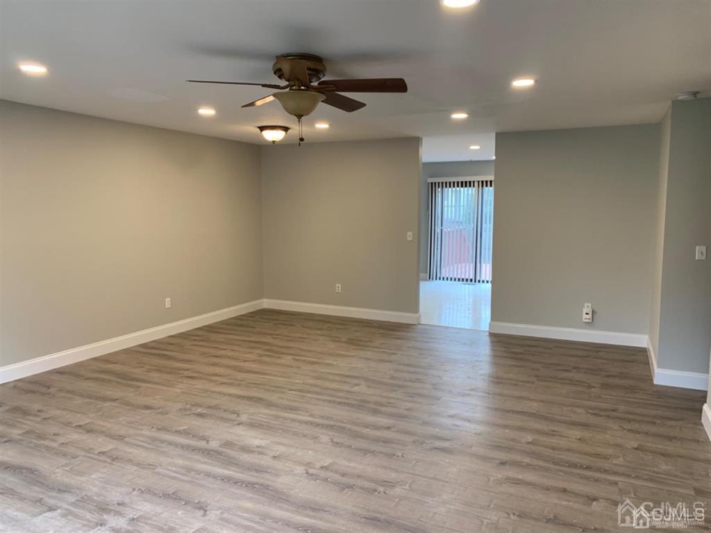 24 Pendleton Place Old Bridge, NJ 08857 - Photo 2 of 22 a view of an empty room with wooden floor and a ceiling fan