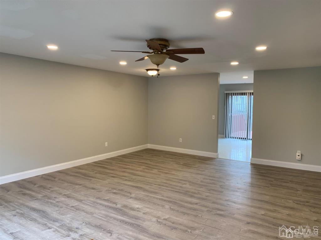 24 Pendleton Place Old Bridge, NJ 08857 - Photo 4 of 22 a view of an empty room with wooden floor and a ceiling fan