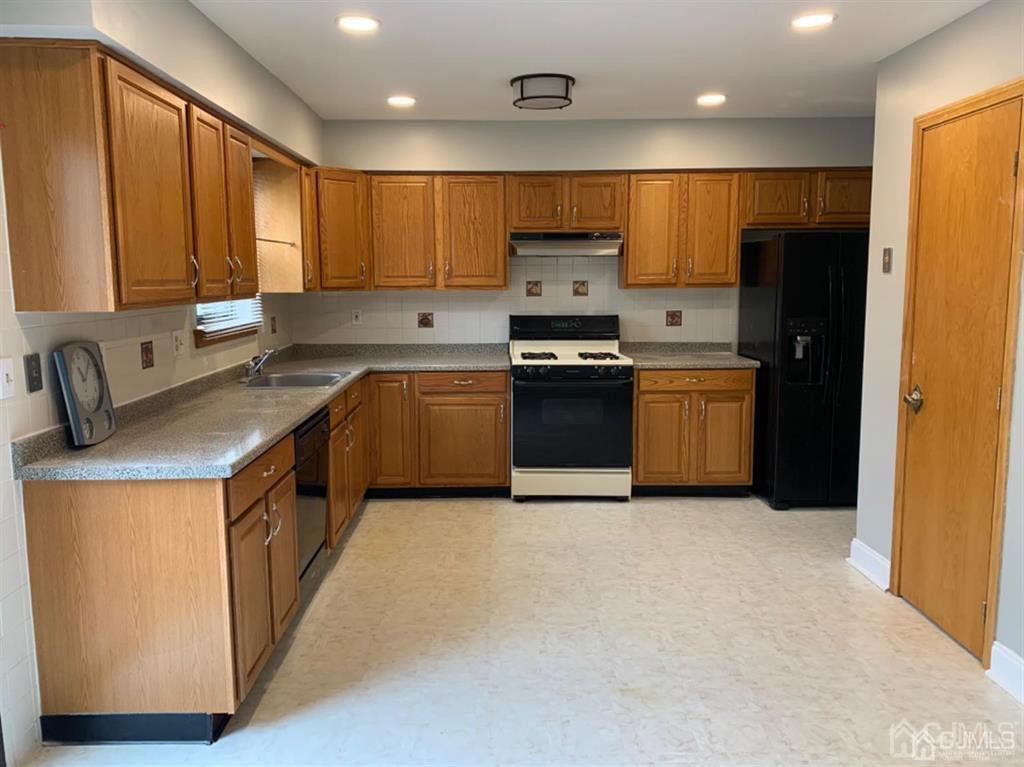 24 Pendleton Place Old Bridge, NJ 08857 - Photo 5 of 22 a kitchen with stainless steel appliances granite countertop a stove a sink dishwasher a refrigerator and a microwave