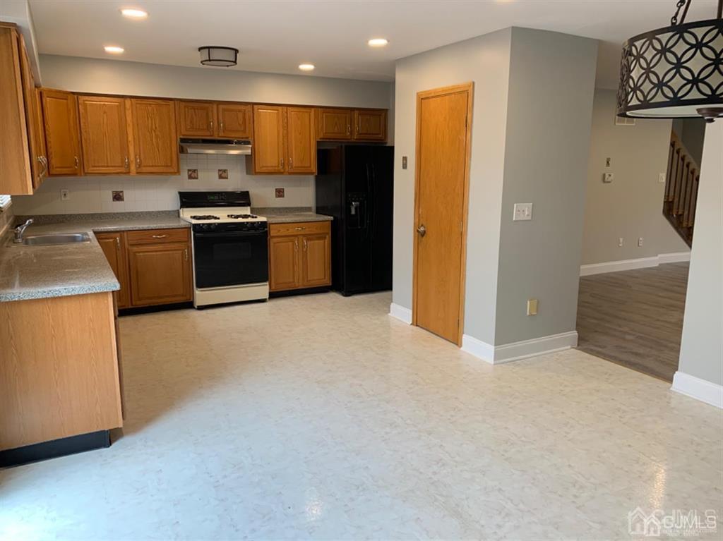 24 Pendleton Place Old Bridge, NJ 08857 - Photo 6 of 22 a kitchen with stainless steel appliances a refrigerator stove and sink