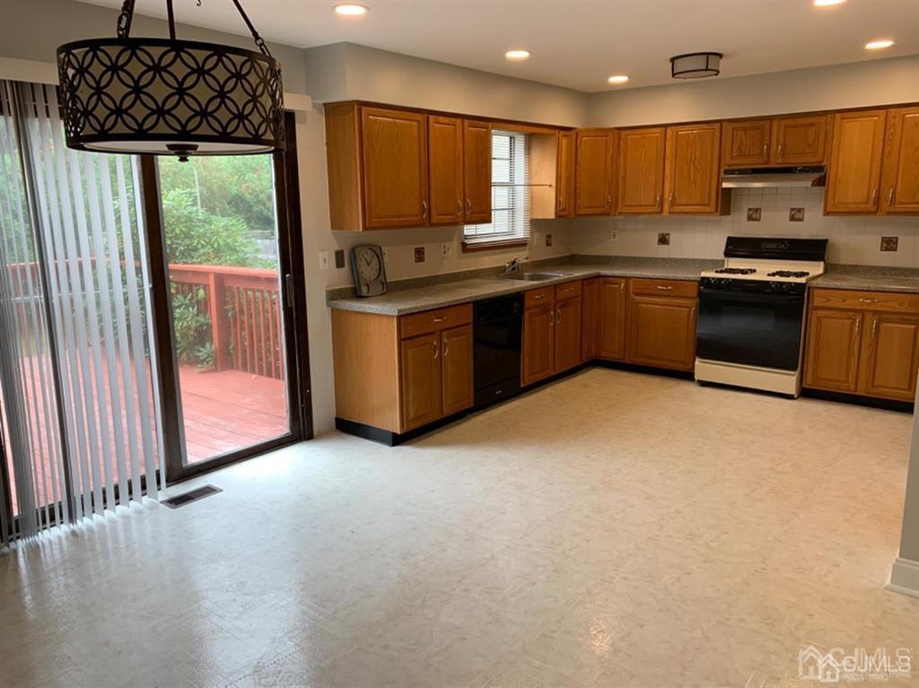 24 Pendleton Place Old Bridge, NJ 08857 - Photo 7 of 22 a kitchen with stainless steel appliances granite countertop a stove sink and cabinets