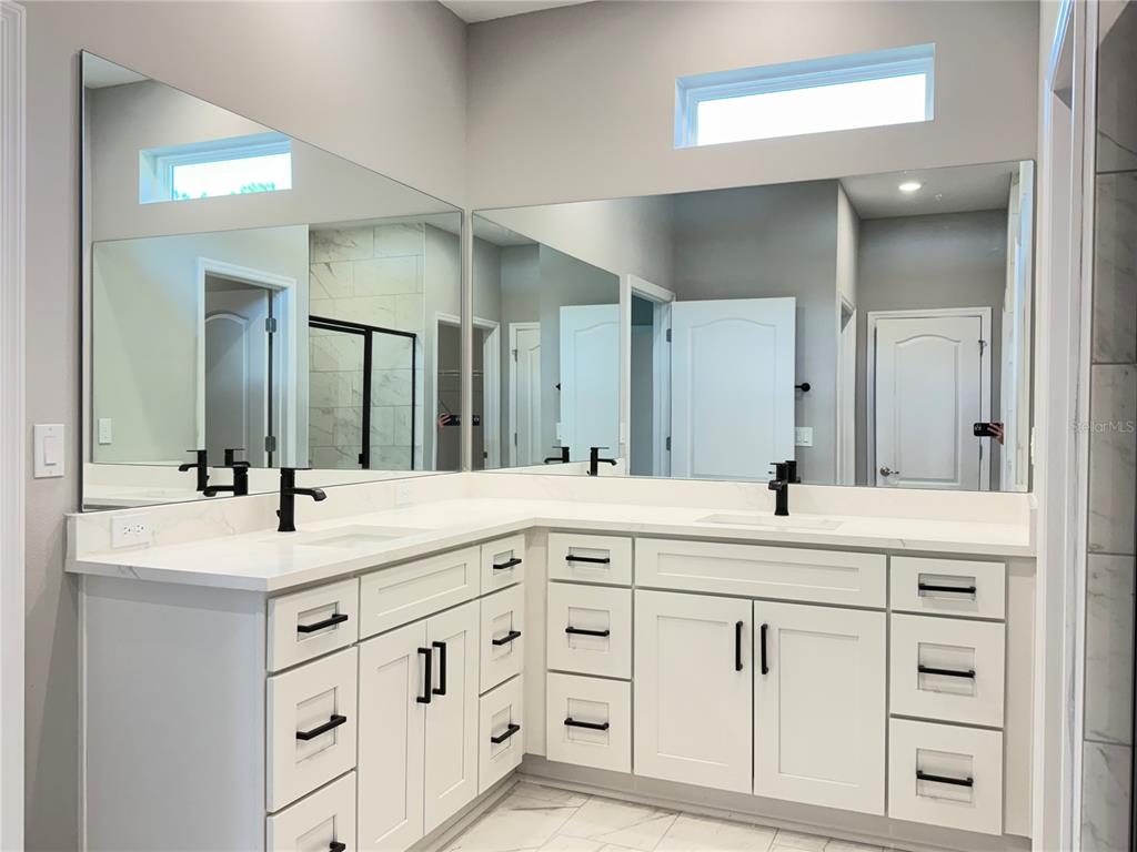 7815 Southwest 128th St Road Ocala, FL 34473 - Photo 24 of 40 a bathroom with a sink and a mirror