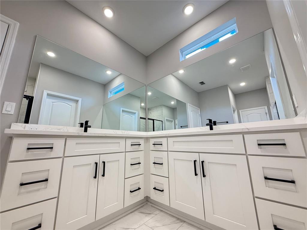 7815 Southwest 128th St Road Ocala, FL 34473 - Photo 25 of 40 a bathroom with a sink vanity and mirror