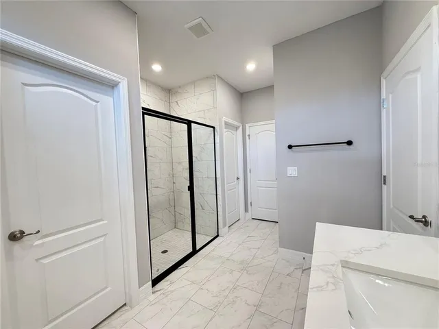 a bathroom with a shower and a tub