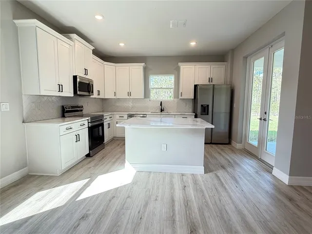 a kitchen with a sink stove and refrigerator