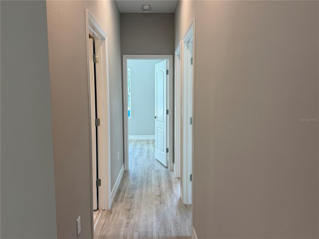 7815 Southwest 128th St Road Ocala, FL 34473 - Photo 10 of 40 a view of a hallway with wooden floor